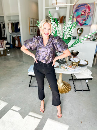 Woman posing in a stylish room with decor and furniture.