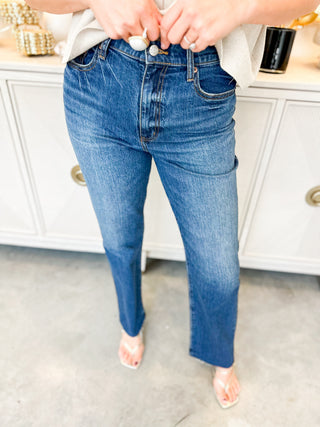 Person wearing blue jeans in a kitchen setting